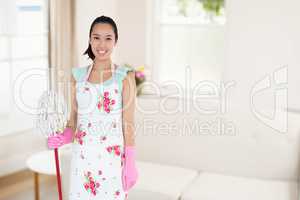 Composite image of happy woman with mop and bucket