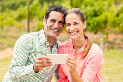 Portrait of happy couple holding mobile phone