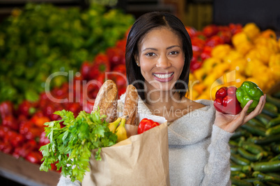 Woman holding vegetables in organic section