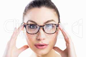 Portrait of beautiful woman posing with spectacles against white background