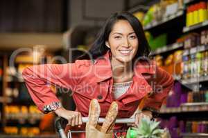 Woman holding shopping cart in organic section