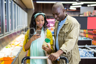 Smiling couple shopping in grocery section