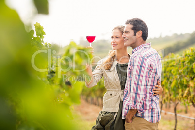 Happy couple looking at glass of wine