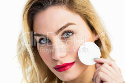 Portrait of beautiful woman posing with make-up sponge