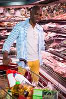 Man looking at goods in grocery section while shopping in supermarket