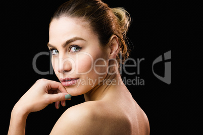 Portrait of beautiful woman posing against black background