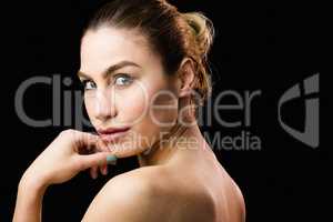 Portrait of beautiful woman posing against black background