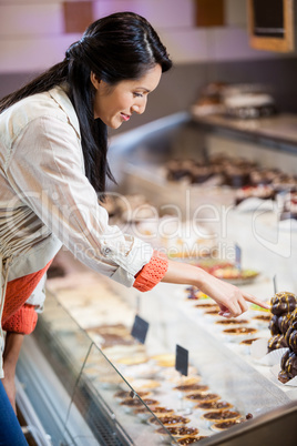Happy woman selecting desserts