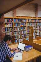 Student using laptop in library