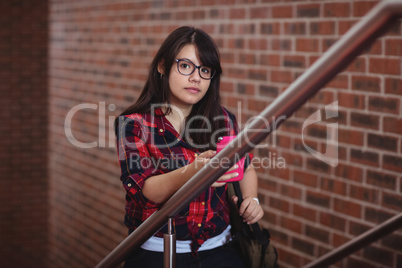 Female student walking on staircase