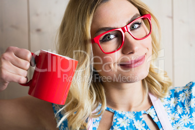 Portrait of woman holding a coffee mug against texture background