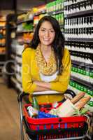 Woman standing with shopping cart in grocery section