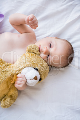 Baby lying on baby bed