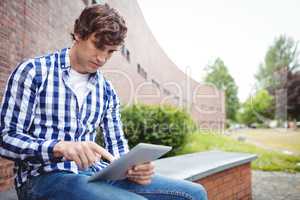 Student using digital tablet in campus