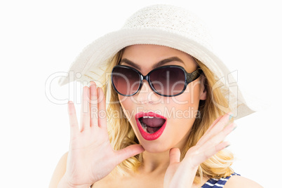 Beautiful woman posing with shocked expression against white background