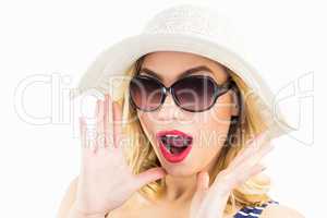 Beautiful woman posing with shocked expression against white background