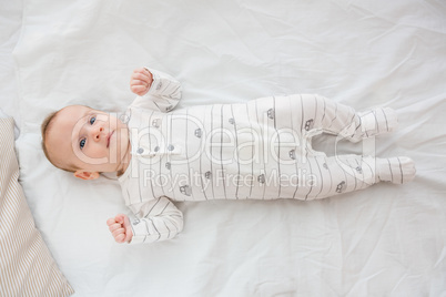 Cute baby boy relaxing on bed