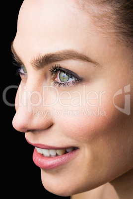 Beautiful smiling woman against black background