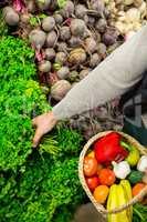 Woman selecting vegetables in organic section