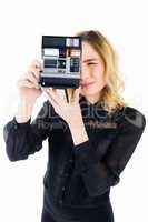Woman clicking photo from camera against white background