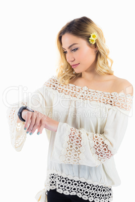 Beautiful woman checking time on smartwatch