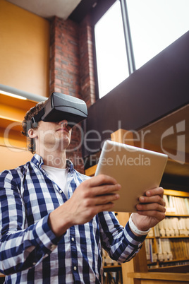 Student using digital tablet and virtual reality headset in library
