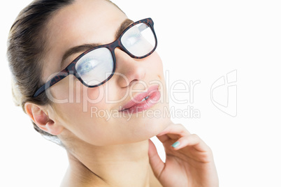 Portrait of beautiful woman posing with spectacles against white background