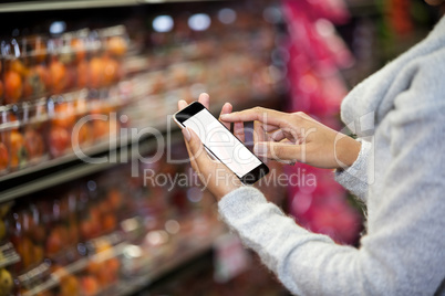 Mid section of woman using mobile phone