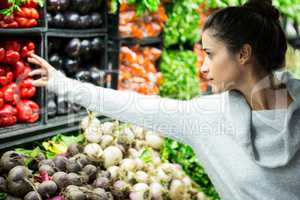 Woman buying vegetables in organic shop