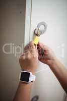 Female student locking her locker