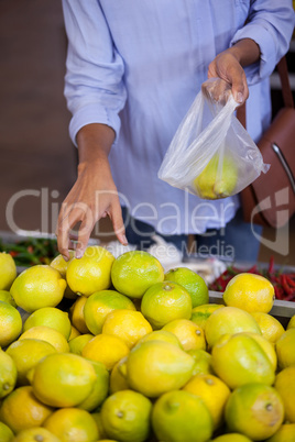 Woman buying sweet lime