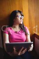 Female student holding digital tablet