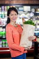 Woman holding groceries in paper bag