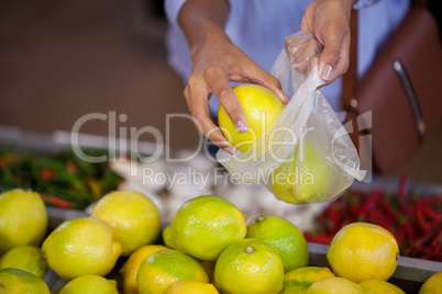 Woman buying sweet lime