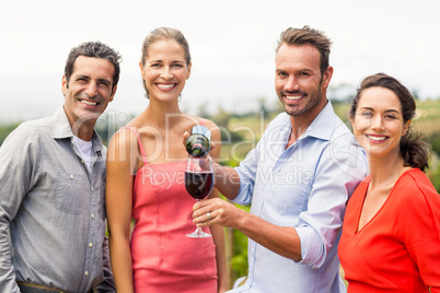 Portrait of happy friends having wine