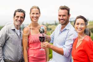 Portrait of happy friends having wine