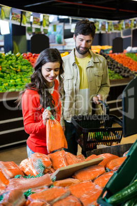 Couple buying vegetables in organic shop