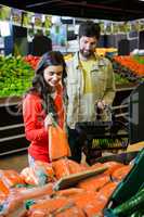 Couple buying vegetables in organic shop