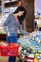 Woman selecting dairy products in grocery section
