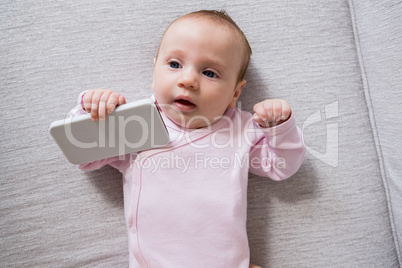 Baby lying on sofa in living room