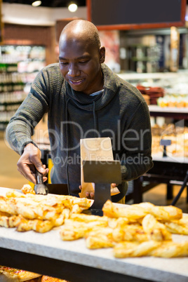 Smiling man purchasing bread