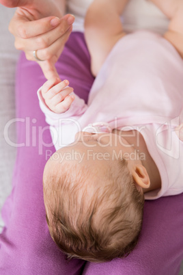 Mother playing with her baby in bedroom