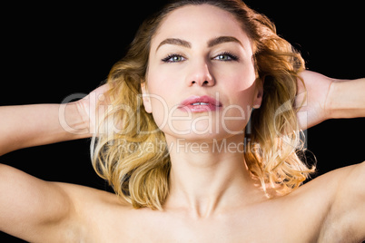 Portrait of beautiful woman posing against black background