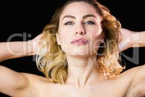 Portrait of beautiful woman posing against black background