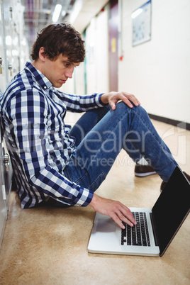Student using laptop in locker room