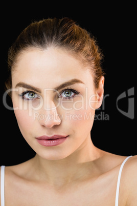 Portrait of beautiful woman posing against black background