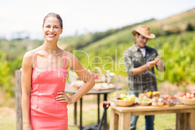 Portrait of female customer standing in front of stall