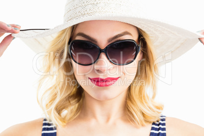 Beautiful woman posing with hat against white background