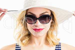 Beautiful woman posing with hat against white background