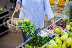 Woman buying sweet lime in organic section